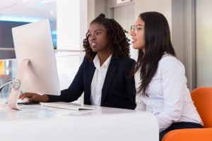 Female office workers using a desktop computer